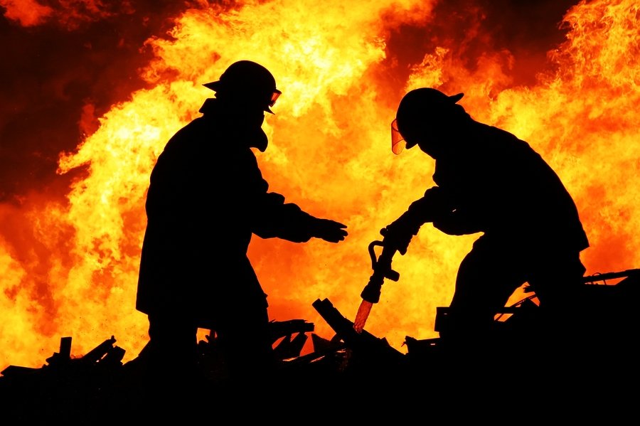 Professional Restoration Services | Horsham, PA Firemen in silhouette against a raging fire