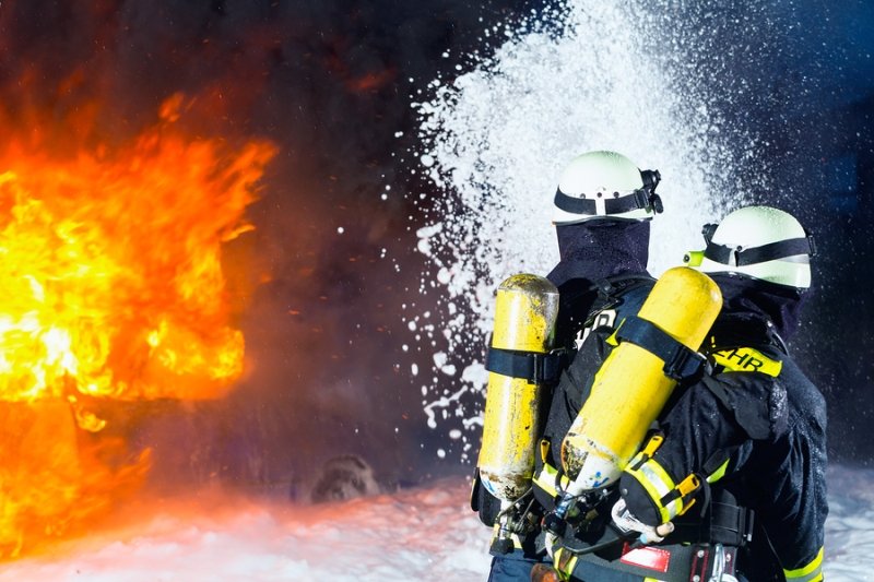 Firemen blasting water on a conflagration